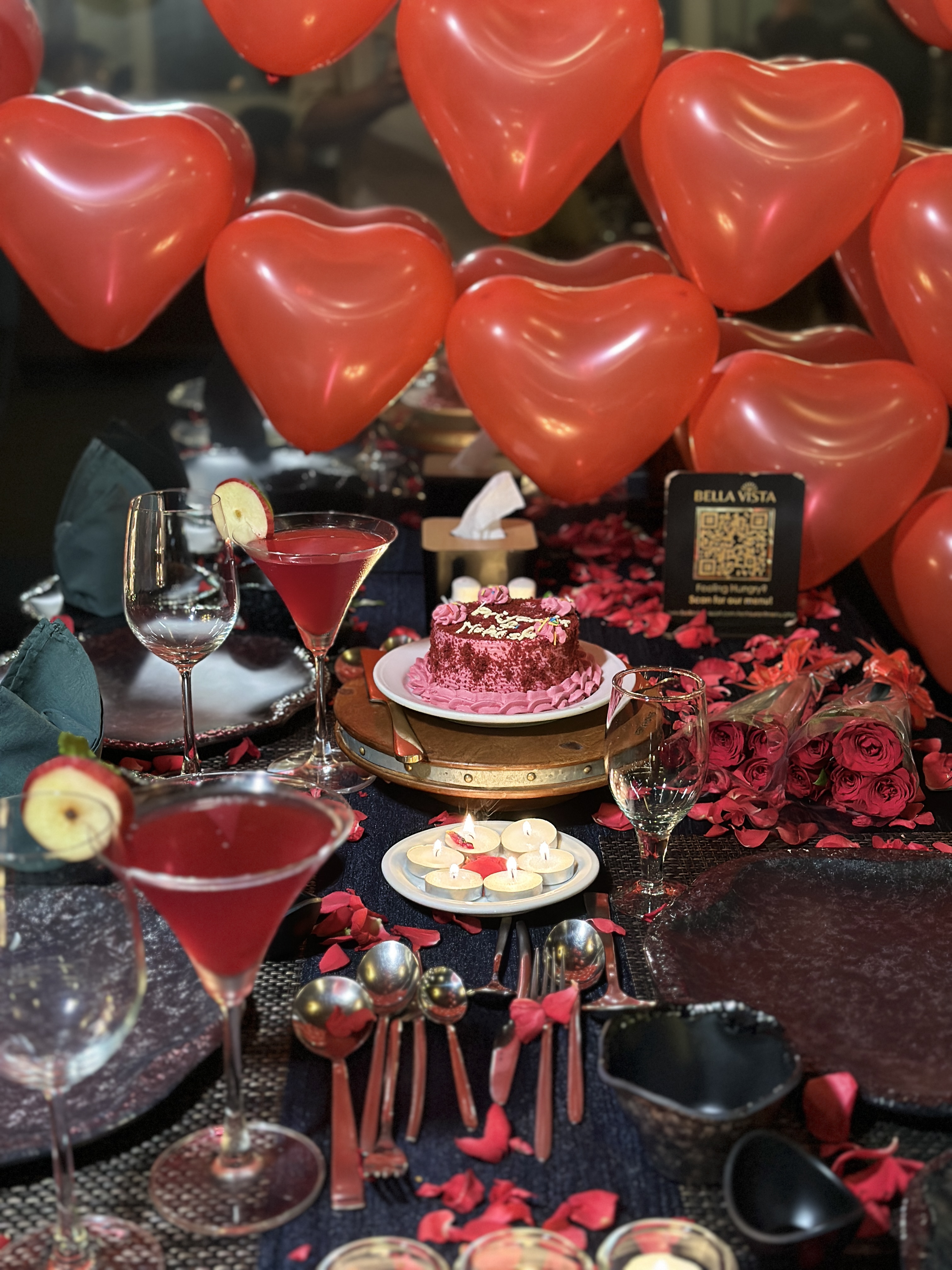 Candlelit dinner setup with heart balloons